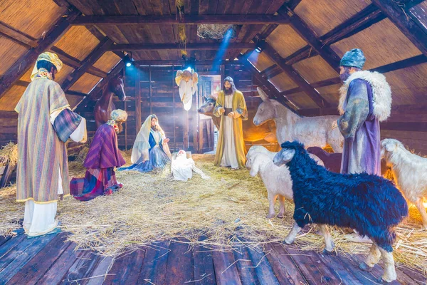 Christmas scene with three wise men presenting gifts to baby Jesus, Mary & Joseph