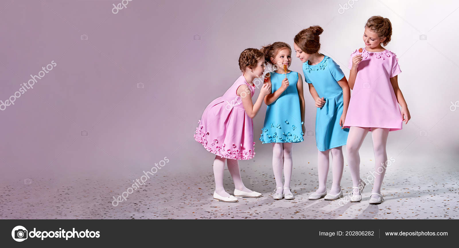 Group little girl in beautiful pink,blue  children advertise  clothes for clothing ,pastel background banner,copy space for  text,shop,advertising. Concept fashion models kids. Stock Photo by  ©Valendina 202806282