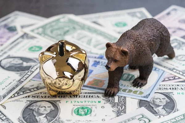 Bear market investing concept, golden piggy bank with bear figur