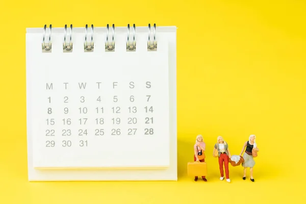 Travel schedule or reminder calendar concept, miniature people g