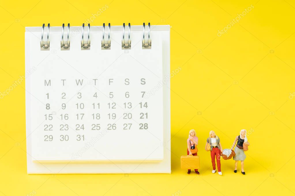 Travel schedule or reminder calendar concept, miniature people g