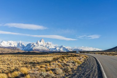 Beautiful asphalt road Route 40 with background of Fitz Roy and  clipart