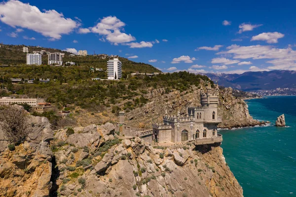Castle Swallow's Nest on a rock at Black Sea, Crimea. Castle is located in the urban area of Gaspra, Yalta. Aerial drone view — Stock Photo, Image