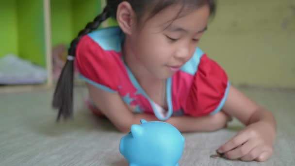Liten Asiatisk Flicka Sätta Pengar Mynt Spargris Bank — Stockvideo