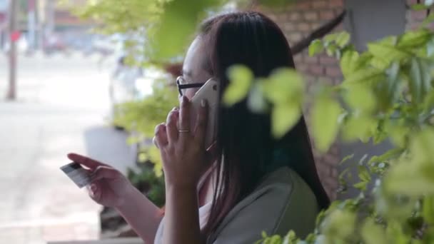 妇女在网上购物时使用智能手机和信用卡 — 图库视频影像