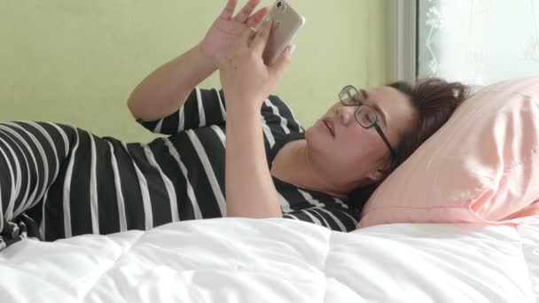 Ασιάτισσα Γυναίκα Που Χρησιμοποιεί Έξυπνο Τηλέφωνο Ξαπλωμένη Στο Κρεβάτι Ένα — Αρχείο Βίντεο