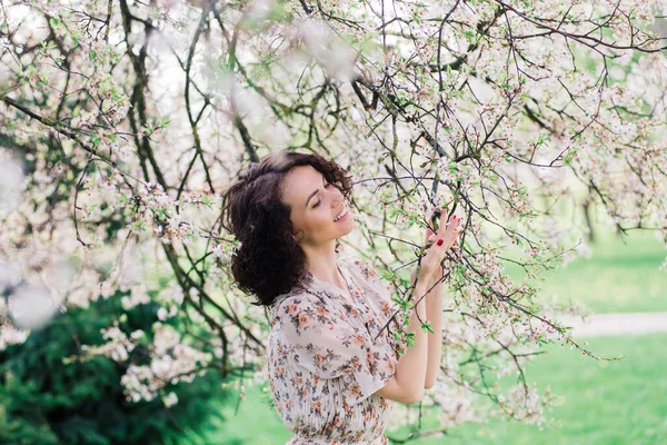 Mujer Atractiva Joven Con Pelo Largo Rizado Posando Jardín Floreciente —  Fotos de Stock