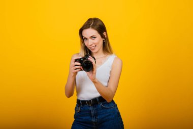 Stüdyoda çalışan heyecanlı bayan fotoğrafçı. Çekici sarışın kızın fotoğrafı. Kameralı..