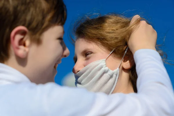 Children in a city park in a medical mask. Walking on the street during the quarantine period of the coronavirus pandemic in the world. Precautions children