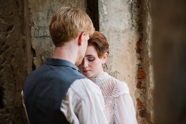 Very nice redhead young just married happy couple kissing in the sunset outdoors