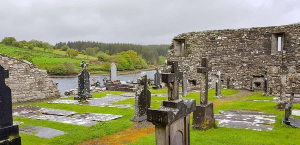 waterside scenery showing a old graveyard seen in Connemara, a region in Ireland