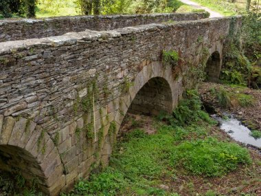 Arches of an old stone bridge (called Ponte Aspera) - Sarria, Galicia, Spain clipart