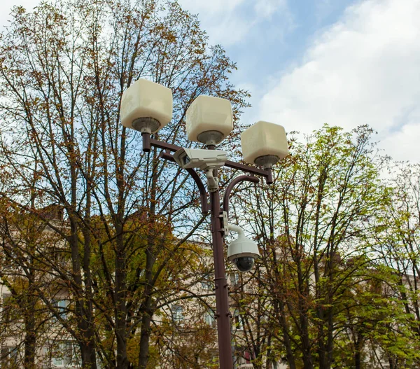 Surveillance camera hangs on a pole in the city