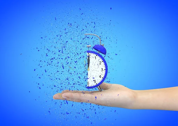 Alarm clock blue on a blue background explodes in the girl's hands — Stock Photo, Image