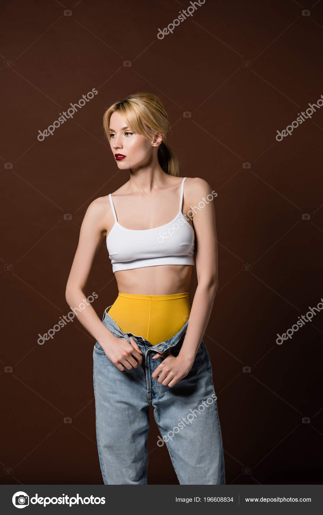 Beautiful Stylish Blonde Girl Yellow Tights Jeans Looking Away Isolated  Stock Photo by ©Y-Boychenko 196608834