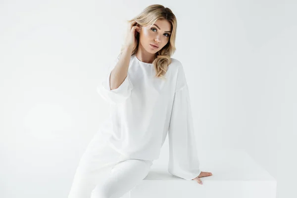 Portrait Young Beautiful Blond Woman White Clothing Sitting Cube Isolated — Stock Photo, Image