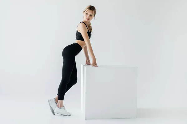 Side View Sportive Woman Black Sportswear Standing White Cube Grey — Stock Photo, Image