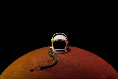 helmet from spacesuit lying on mars planet in black universe clipart