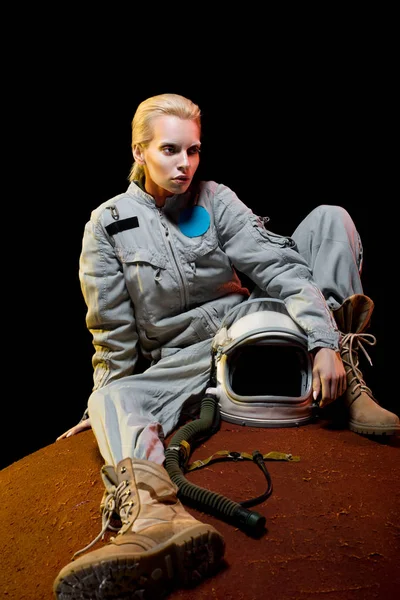 Attractive Cosmonaut Spacesuit Holding Helmet Sitting Planet — Free Stock Photo