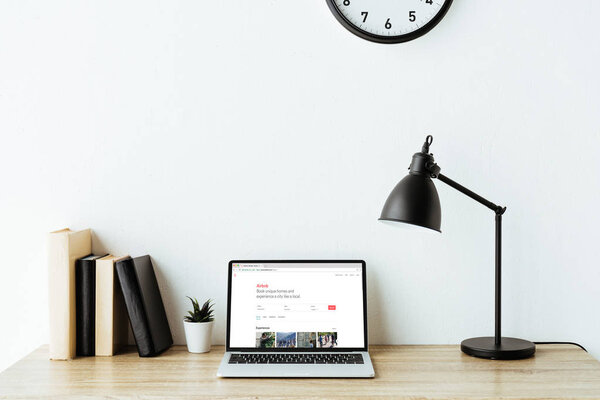 laptop with airbnb website on screen on work desk at office