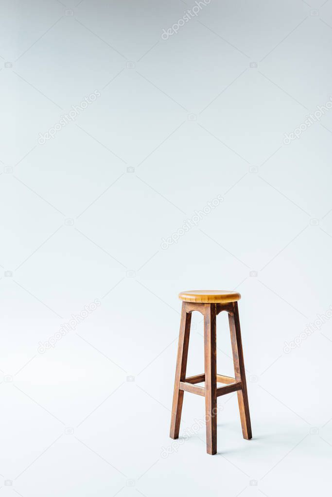 single vintage wooden stool on white