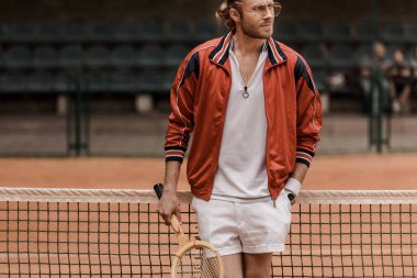 Tenis Kortu, raket ile ayakta yakışıklı retro tarz tenis oyuncusu