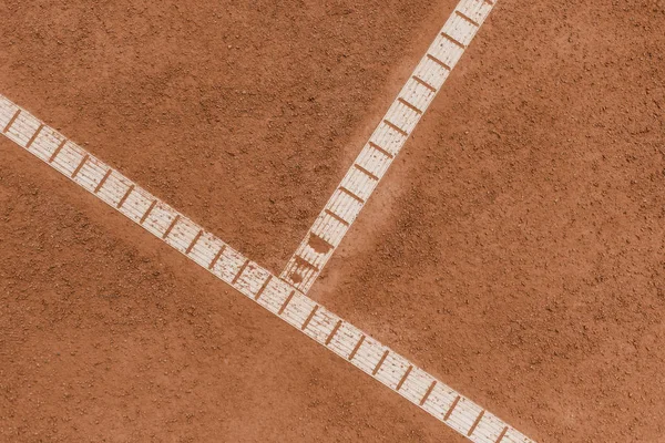 elevated view of brown tennis court with marking lines