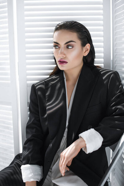 elegant beautiful young woman posing in black jacket 