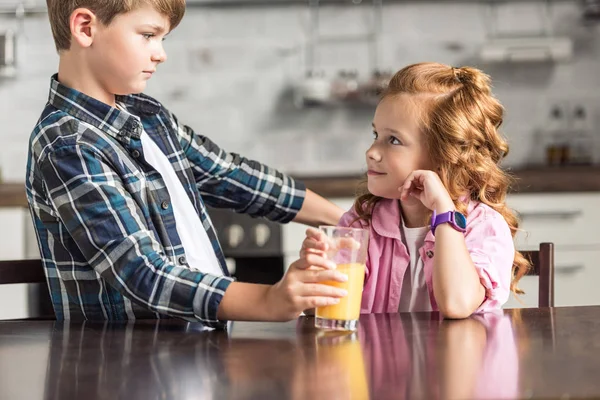 Little Brother Giving Glass Orange Juice His Sister — Free Stock Photo
