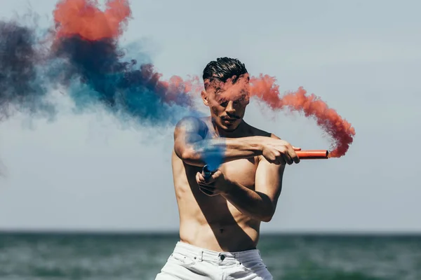 Handsome Shirtless Man Red Blue Smoke Sticks Front Ocean View — Stock Photo, Image