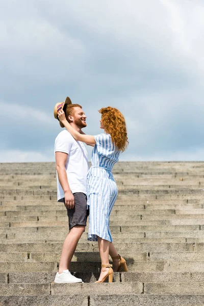 Attractive Redhead Woman Putting Own Straw Hat Boyfriends Head Stairs — Stock Photo, Image