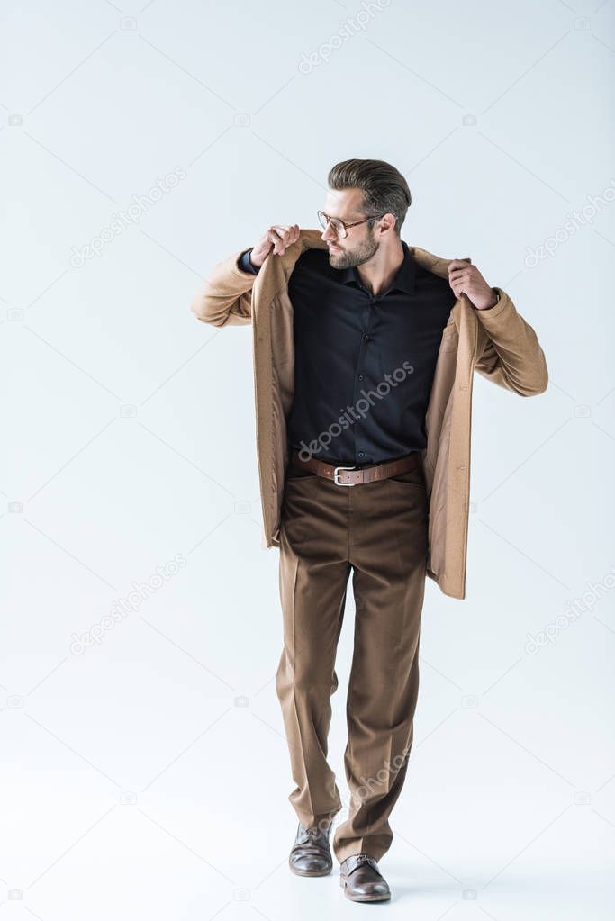 handsome bearded man posing in stylish autumn outfit, isolated on white