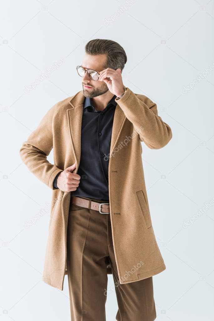 stylish man posing in eyeglasses and autumn outfit, isolated on white