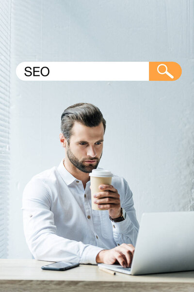 Concentrated Developer Holding Coffee While Working Laptop Seo Search Bar Stock Picture