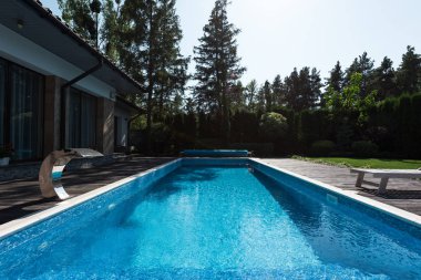 view of modern house with blue swimming pool  clipart