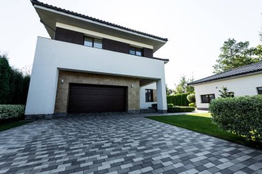 facade of new modern house with empty parking and lawn clipart