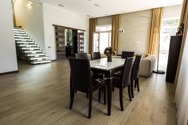 interior view of modern dining room with table, chairs and stairs clipart