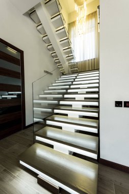 interior view of empty modern stairs with glass railings and door   clipart