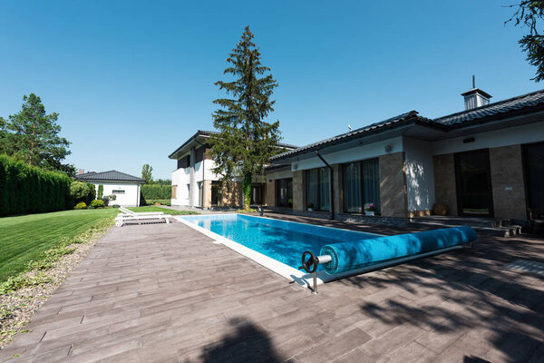 view of house exterior and swimming pool with daylight