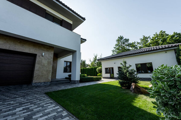 modern private house with green lawn and garden