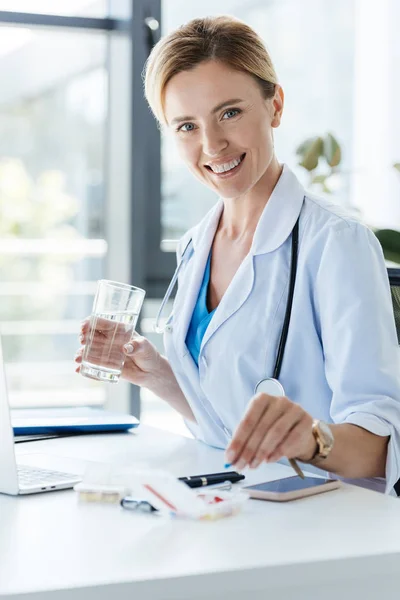 Smiling Female Doctor Holding Glass Water Taking Pill Table Office — Stock Photo, Image