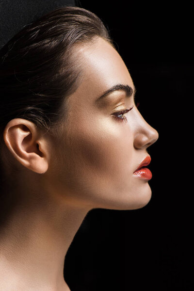 profile portrait of attractive stylish girl with makeup, isolated on black