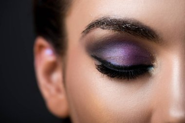 close up of girl with closed eye and glitter eyeshadows, isolated on grey clipart