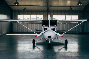 modern small airplane standing in hangar 