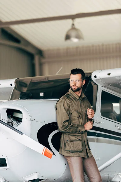 Young Stylish Man Green Jacket Eyeglasses Looking Away Airplane — Free Stock Photo