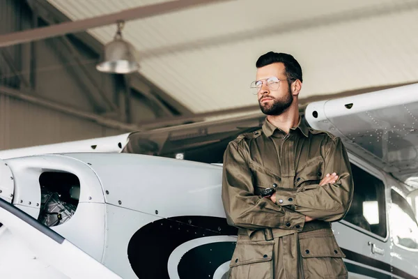 Fashionable Young Man Green Jacket Eyeglasses Posing Crossed Arms Airplane — Stock Photo, Image