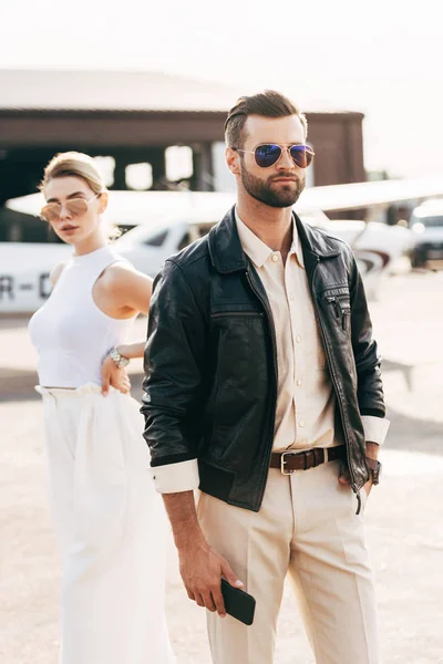 Handsome Stylish Man Sunglasses Leather Jacket Holding Smartphone While His — Stock Photo, Image