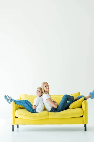 Mother Son Sitting Crossed Arms Yellow Sofa Looking Camera White — Stock Photo, Image