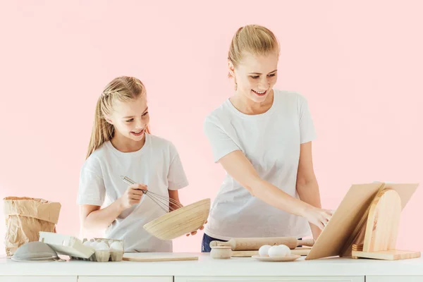 Happy Mother Daughter White Shirts Looking Recipe Book While Cooking — Free Stock Photo