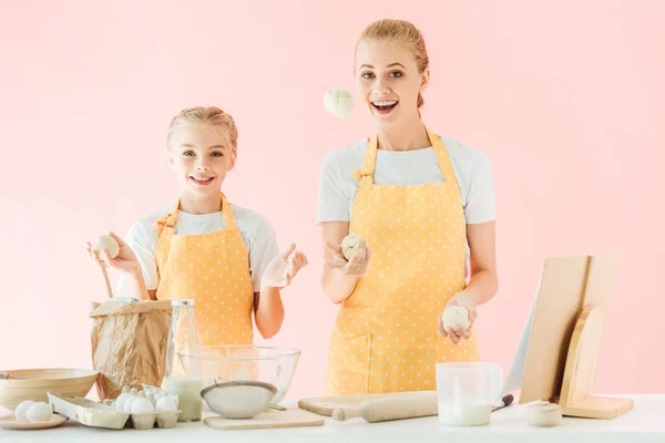 Happy Mother Daughter Juggling Dough Pieces While Cooking Isolated Pink — Stock Photo, Image